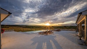 A rooftop terrace with a pool, lounge chairs, and a sunset view. - Charming villa Viliska with heated pool (Sveti Filip i Jakov)