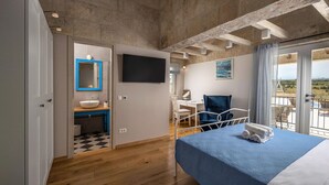 A bedroom with a bed, a desk, a chair, a TV, and a balcony with a view. - Charming villa Viliska with heated pool (Sveti Filip i Jakov)