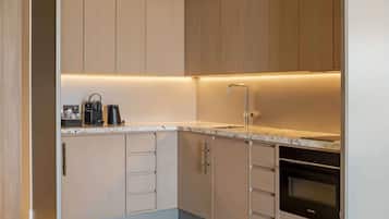 A modern kitchen with built-in appliances, a sink, and a Siemens oven.