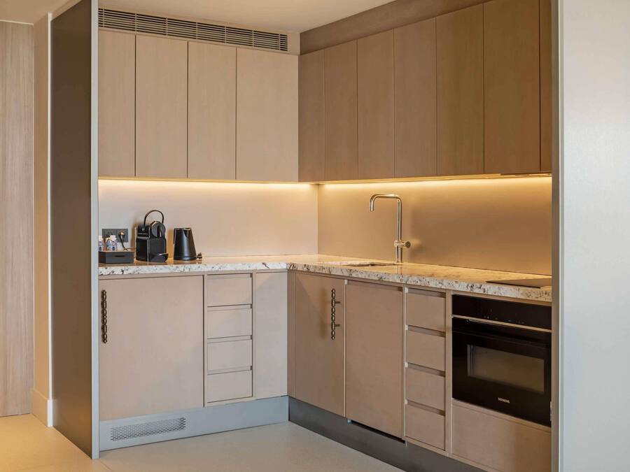 A modern kitchen with built-in appliances, a sink, and a Siemens oven.