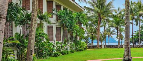 A building with a pathway leading to a beach.