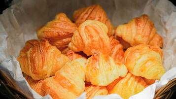 A basket of golden-brown croissants.