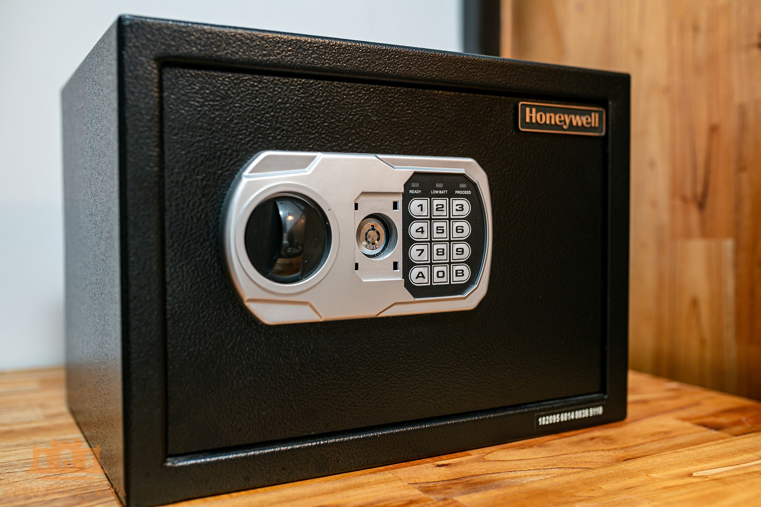 A black safe with a Honeywell brand lock and keypad.