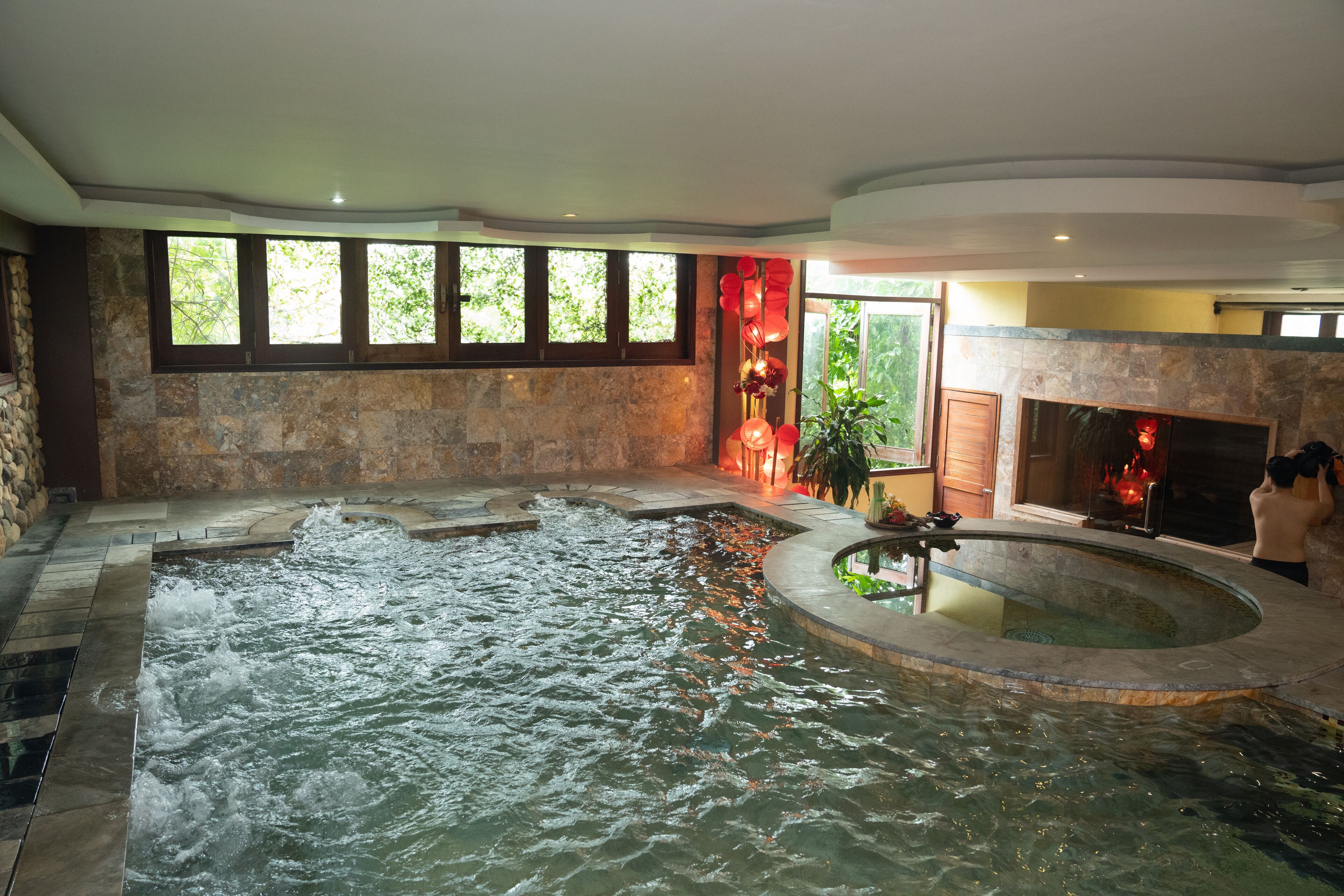A spa area with a hot tub and a fireplace.