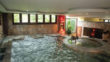 A spa area with a hot tub and a fireplace.