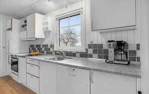 Fridge, stovetop, dishwasher, coffee/tea maker