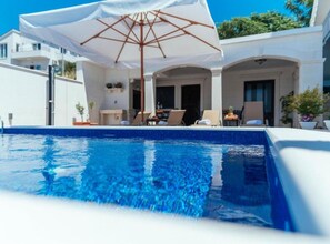 Seasonal outdoor pool, pool umbrellas, pool loungers