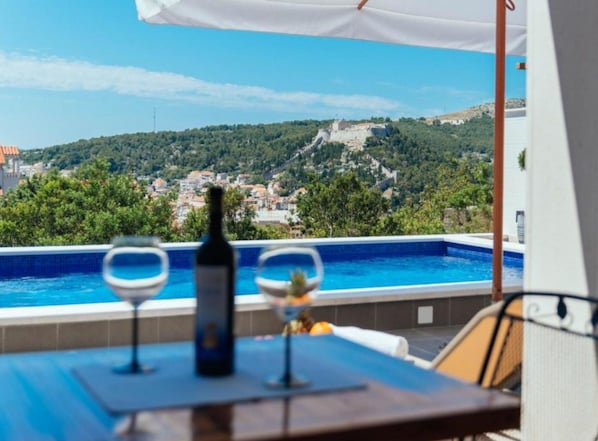 Seasonal outdoor pool, pool umbrellas, pool loungers