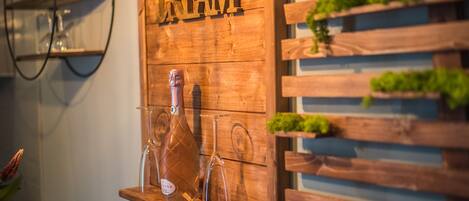 A wooden shelf with a bottle and glasses, and a sign that reads "DREAM".