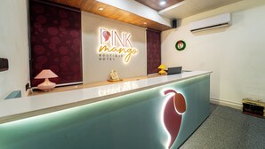A reception desk with a sign reading "Pink Mango Boutique Hotel." - Pink Mango A Boutique Hotel (Hisar)