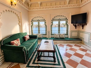 A room with a green sofa, a marble coffee table, and a checkered floor. - Hotel Amet Haveli (Udaipur)