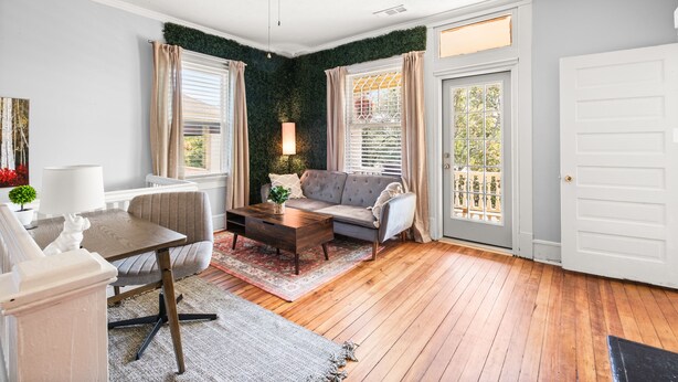 Een gezellige woonkamer met een bank, bijzettafeltje en een plafondventilator.