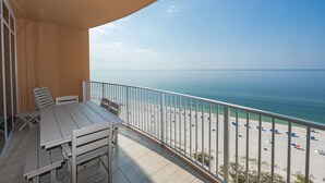 A balcony with a view of a beach and the sea. - Phoenix Gulf Towers 1406 2 Bedroom Condo (Orange Beach)