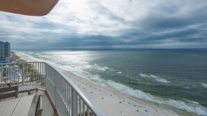A beach with a walkway and a railing.