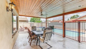 A covered patio with a pool, outdoor furniture, and a wooden ceiling. - Private Pool & Patio: Home Near Mesa Arts Center! (Mesa)