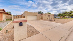 A residential area with a paved driveway, a mailbox, and a garage door. - Private Pool & Patio: Home Near Mesa Arts Center! (Mesa)