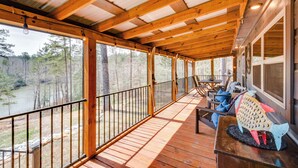 A wooden deck with a railing, a table, and a fish sculpture. - Waterfront Seneca Cabin ~ 4 Mi to Boat Launch! (Seneca)