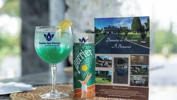 A glass of Perrier water, a brochure for Domaine de Brachieux, and a placemat.