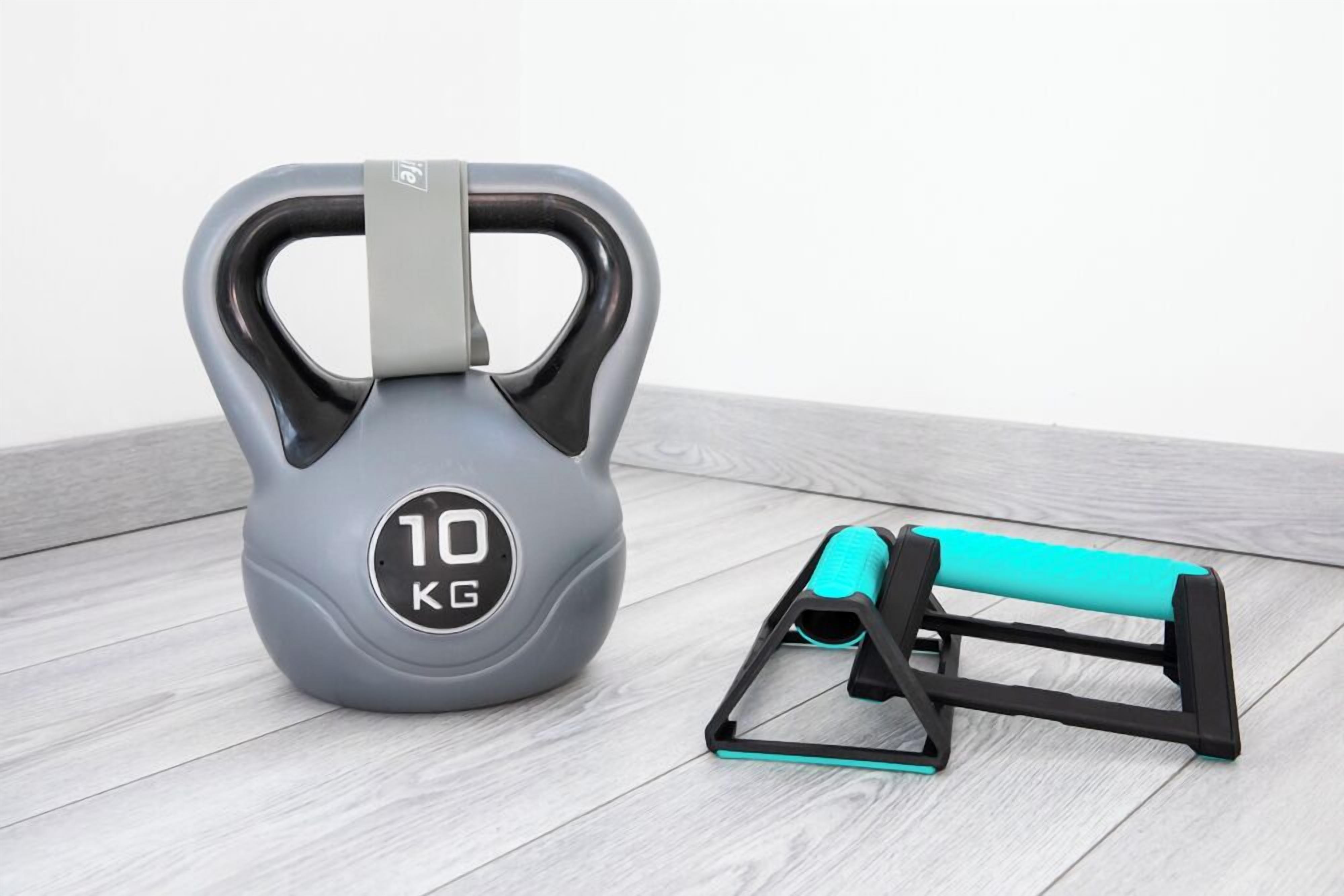 A grey kettlebell with a handle and a weight indicator of 10 KG, and a black and turquoise kettlebell stand.