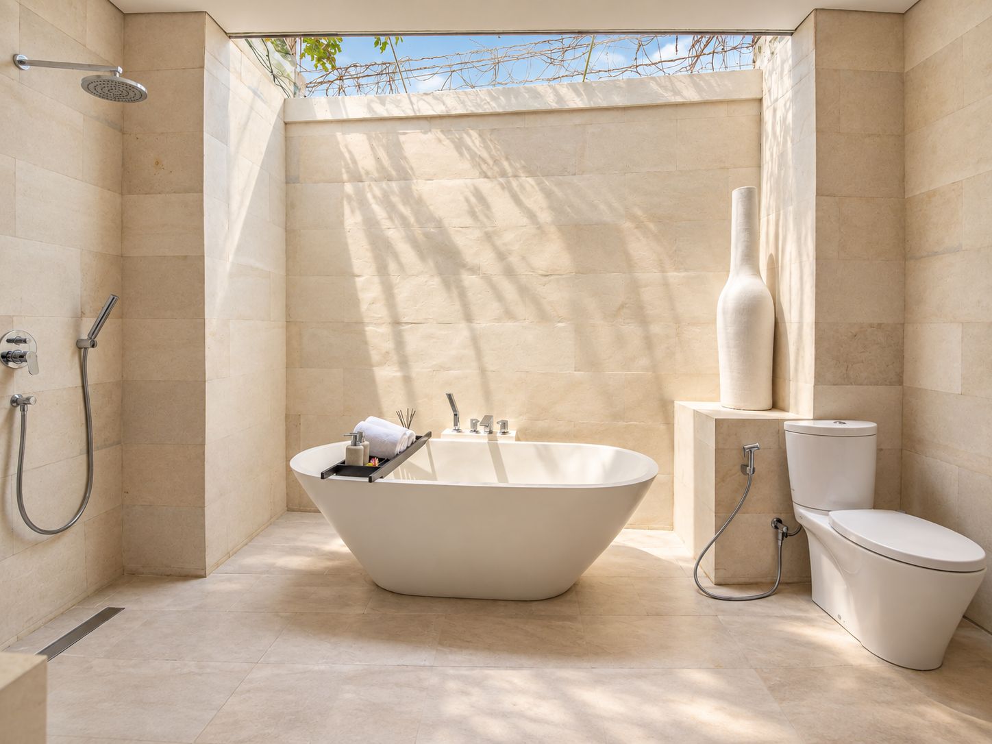 A modern bathroom with a freestanding bathtub, a toilet, and a shower.