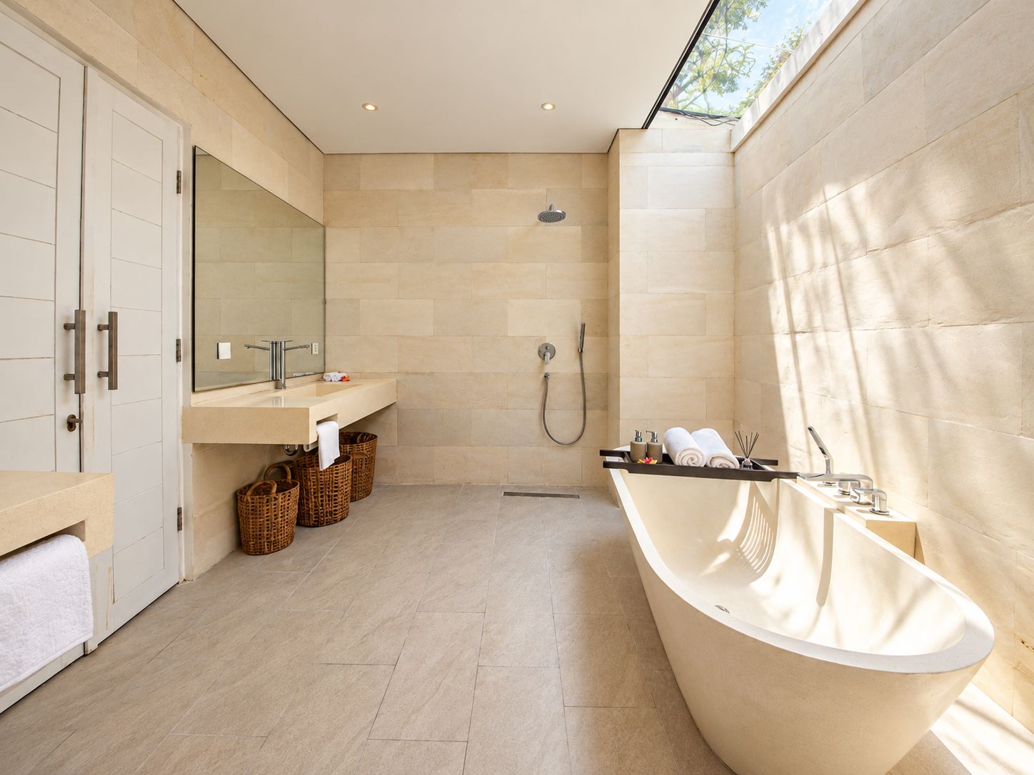 A modern bathroom with a freestanding bathtub, a shower, and a vanity with a mirror.