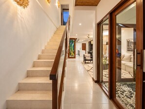 A modern interior with a staircase leading to a dining area. - Exquisite 2BR Villas, Brawah, 300m to Beach (Kuta Utara)