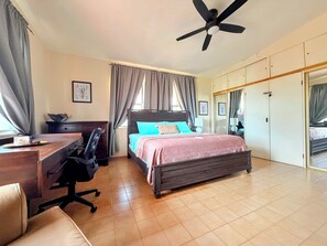 Un dormitorio con cama, escritorio, silla y armario.