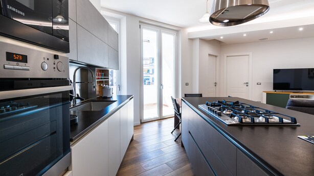 A modern kitchen with a built-in oven, microwave, and gas stove. - Casa del Marchese del Grillo (Rome)