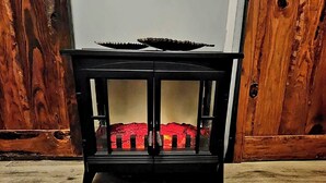 A black cabinet with glass doors and a red interior. - Nature Escape, Outdoor Cinema & River Adventure (Lares)
