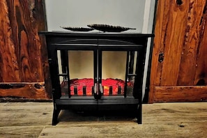 A black cabinet with glass doors and a red interior. - Nature Escape, Outdoor Cinema & River Adventure (Lares)
