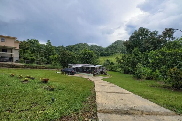 A house with a porch and a car parked in front.