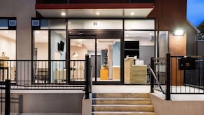 A modern building entrance with a glass door, number 35, and a staircase leading up. - Days Inn By Wyndham Staten Island (Staten Island)