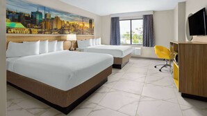 A hotel room with two beds, a desk, a chair, a TV, and a cityscape mural on the wall. - Days Inn By Wyndham Staten Island (Staten Island)