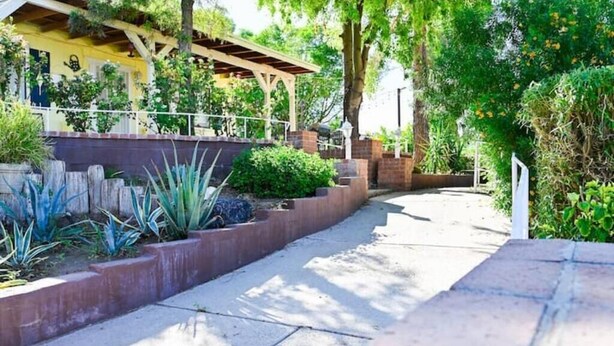 A pathway lined with plants and a covered structure. - Farmhouse Escape w/Mountain Views (Tolleson)