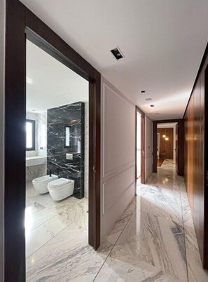 A modern bathroom with a marble vanity and two toilets. - Penthouse Dans le Ciel (Tanger)