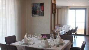 A dining area with tables set for four, each with white tablecloths and napkins. - Hotel Santa Cruz Oran (Oran)