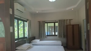 A room with two beds, a window with curtains, a radiator, and a wardrobe. - Private house one bedroom, full furniture, small kitchen, 5 minutes to the beach (Koh Samui)