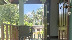 A clean, modern hallway with a reflective floor leading to a balcony with a wicker chair. - Private house one bedroom, full furniture, small kitchen, 5 minutes to the beach (Koh Samui)