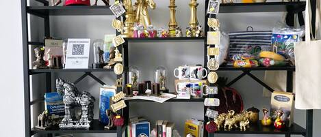 A bookshelf filled with books, decorative items, and a few small figurines.