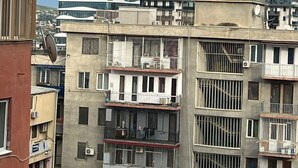 A multi-story building with balconies, air conditioning units, and satellite dishes. - Deluxe seaside Batumi  (Batumi)