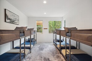A room with bunk beds, a large window, and a painting on the wall. - Sandy River Group Getaway 2 (Mount Hood Village)