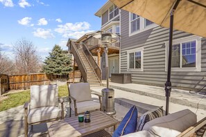 A patio with outdoor furniture, a heater, and a covered area. - Newly Remodeled Walkout Basement w/ Private Entry, full kitchen, private W/D (Parker)