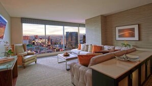 A modern living room with a city view, a sofa set, a coffee table, and a dining area. - Las Vegas | Pool & Strip Access | Vegas Lifestyle Stay (Las Vegas)