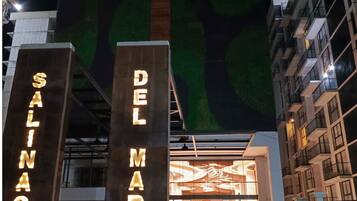 A modern building with illuminated signs reading "SALINAS" and "DEL MAR".