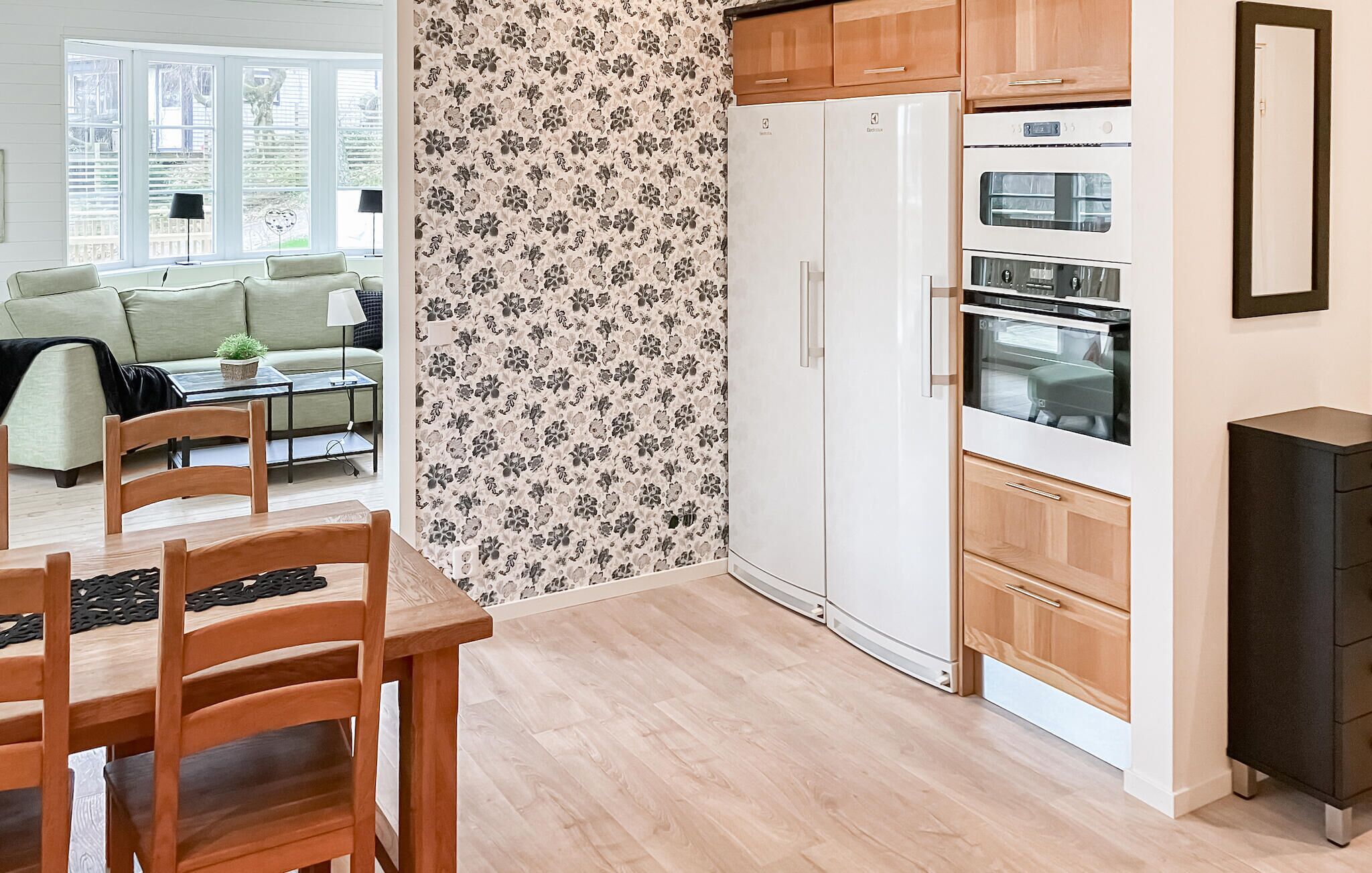 A compact kitchen with a refrigerator, oven, and microwave.