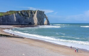 A coastal landscape with cliffs and a beach.