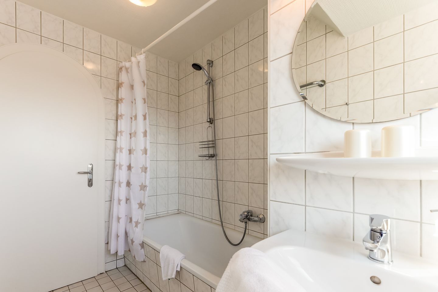 A bathroom with a shower, a bathtub, a sink, and a mirror.