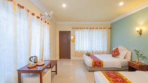 A hotel room with two beds, a wooden table with breakfast items, a wall-mounted lamp, and a door with a sign. - Lotus Bleu Guest House (Siem Reap)