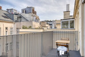 Enjoy a peaceful seating area on the rooftop with a bench and table.