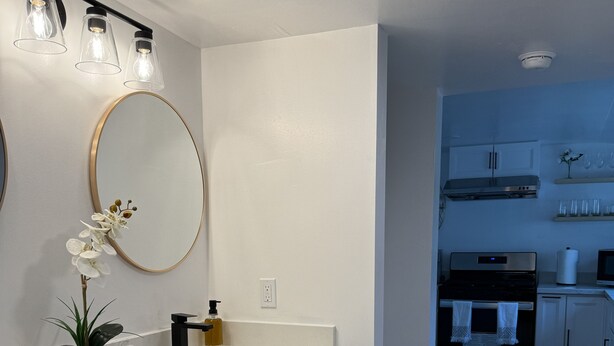 A modern kitchen with white cabinets, a stainless steel stove, and a microwave. - Newly renovated home walkable to Downtown/Restaurants/Park (Ukiah)